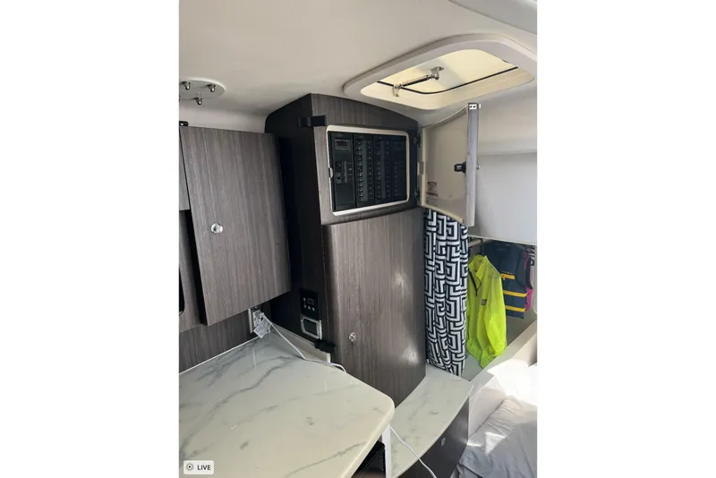 Slide: The Image of Interior of 2015 Intrepid 400 Cuddy with modern cabinetry and control panel. - 32