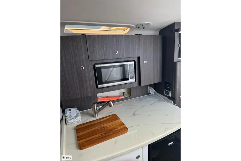 Slide: The Image of Modern kitchen area in 2015 Intrepid 400 Cuddy boat with microwave and cutting board. - 33