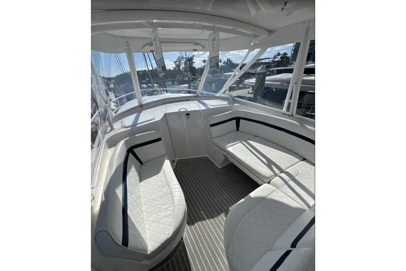 Slide: The Image of Interior of 2015 Intrepid 400 Cuddy boat with white seating and panoramic windows. - 9