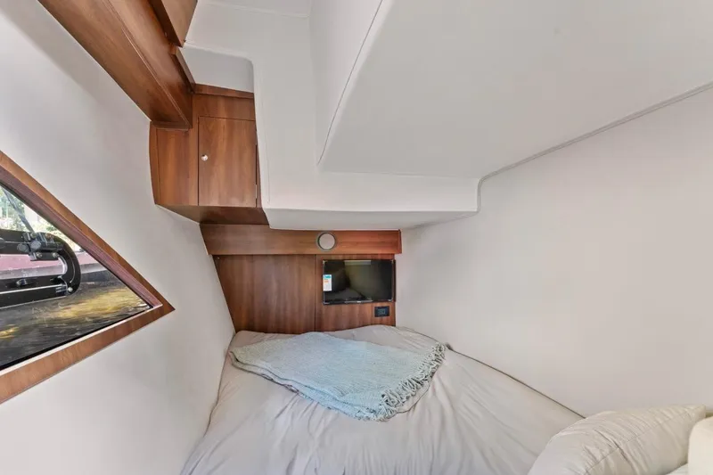 Slide: The Image of Cozy cabin interior of 2026 Valiatt 410 HT with bed, window, and TV. - 9