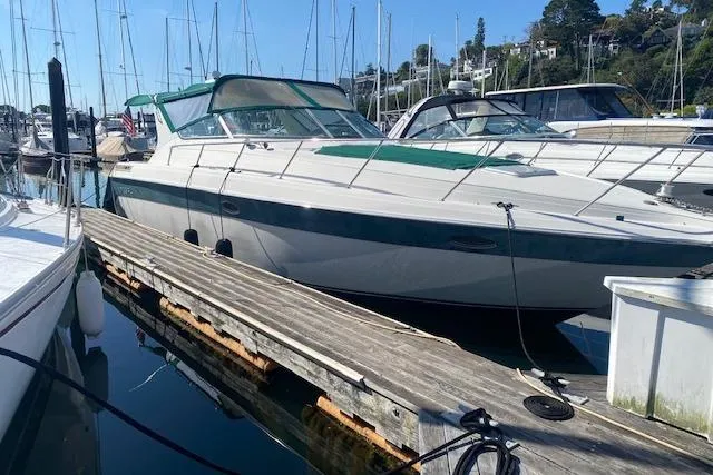 The Image of 1995 Regal 402 boat docked at marina with clear blue sky background. - 0