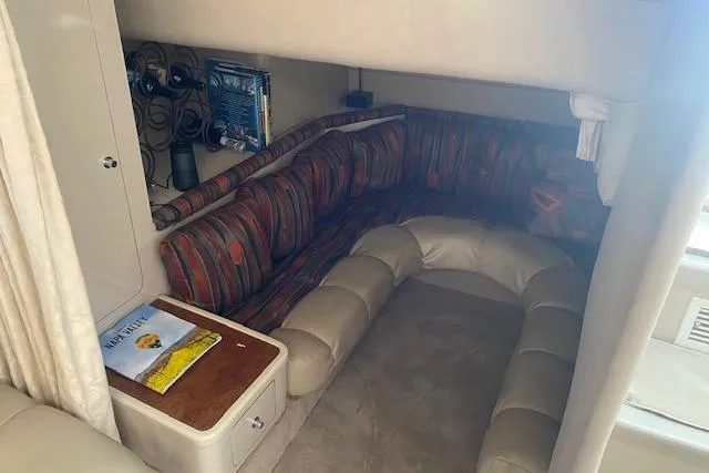 Slide: The Image of Interior of a 1995 Regal 402 boat with cozy seating and storage. - 11