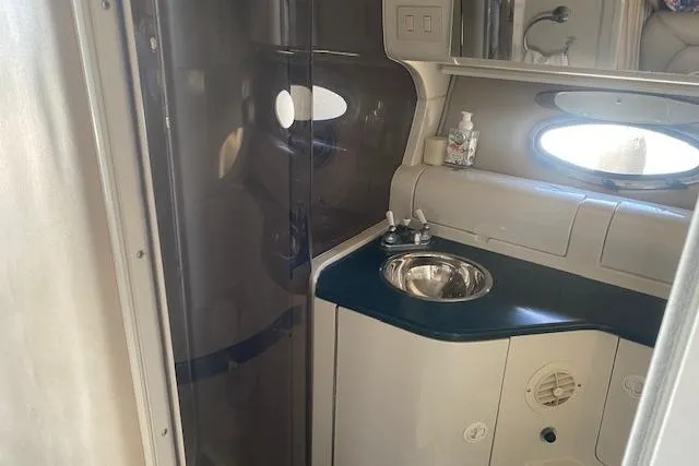 Slide: The Image of Interior of a 1995 Regal 402 boat bathroom with sink and mirror. - 13