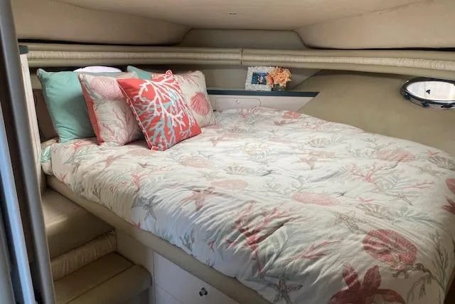 Slide: The Image of Cozy 1995 Regal 402 yacht cabin with floral bedding and decorative pillows. - 14