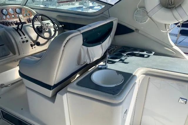 Slide: The Image of 1995 Regal 402 boat interior with steering wheel, sink, and control panel. - 5