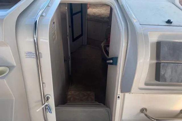 Slide: The Image of Entrance to cabin of 1995 Regal 402 boat, showing interior steps and doorway. - 7