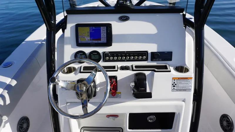 Slide: The Image of 2022 Sea Fox 228 Commander boat dashboard with steering wheel and navigation controls. - 7