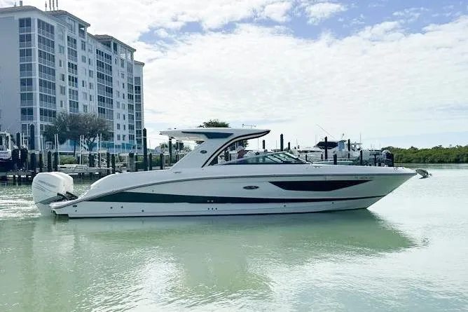 The Image of 2020 Sea Ray SLX 350 Outboard boat docked near waterfront buildings. - 0