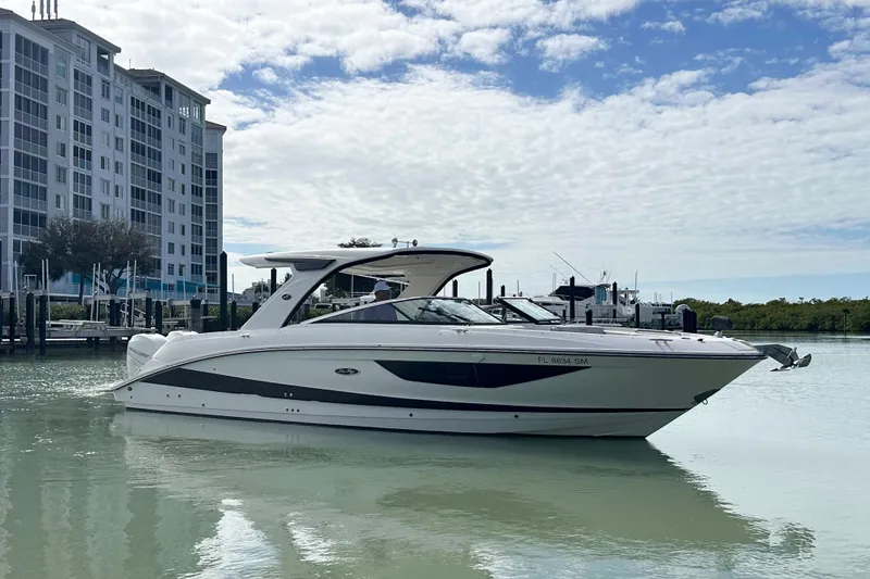 Slide: The Image of 2020 Sea Ray SLX 350 Outboard boat docked near waterfront buildings. - 1