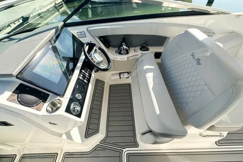 Slide: The Image of 2020 Sea Ray SLX 350 Outboard cockpit with luxurious seating and modern controls. - 12