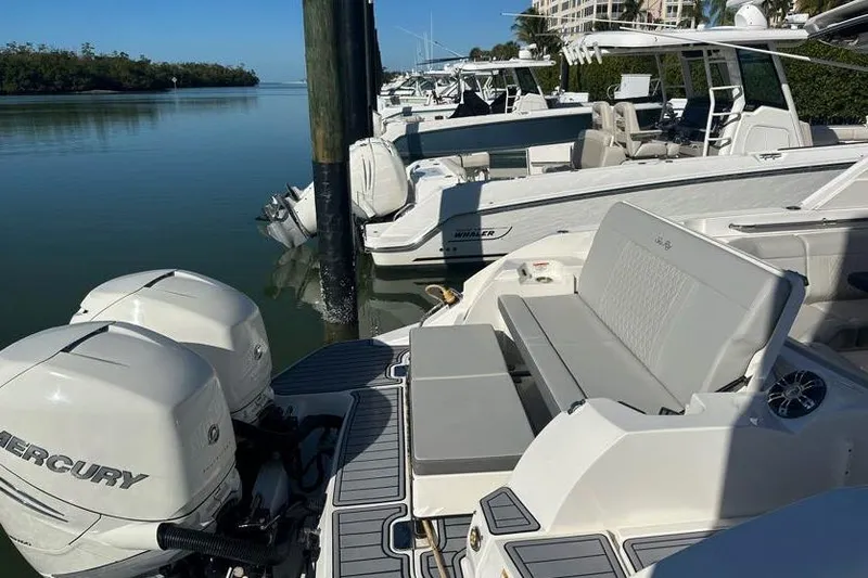 Slide: The Image of 2020 Sea Ray SLX 350 Outboard docked, featuring dual Mercury engines and sleek design. - 15