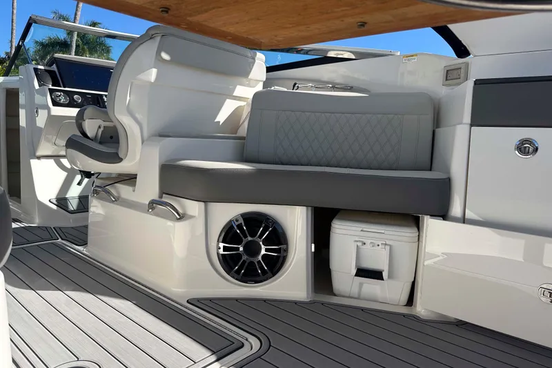 Slide: The Image of 2020 Sea Ray SLX 350 Outboard interior with seating, speaker, and cooler on deck. - 19