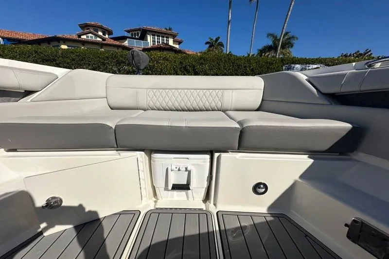 Slide: The Image of 2020 Sea Ray SLX 350 Outboard interior with cushioned seating and sleek design. - 22
