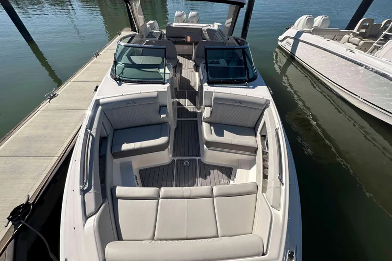 Slide: The Image of 2020 Sea Ray SLX 350 Outboard boat docked, featuring spacious seating and sleek design. - 24