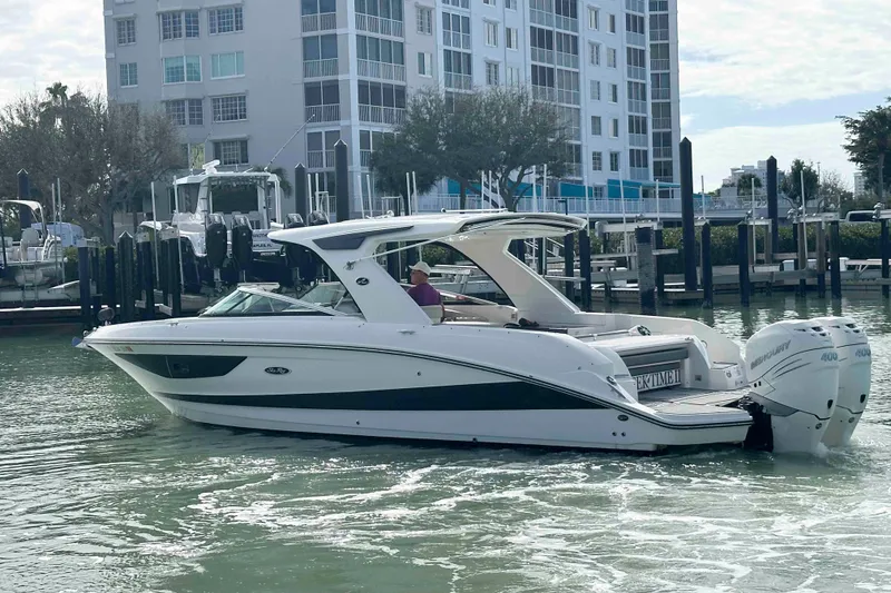 Slide: The Image of 2020 Sea Ray SLX 350 Outboard boat docked near waterfront buildings. - 5