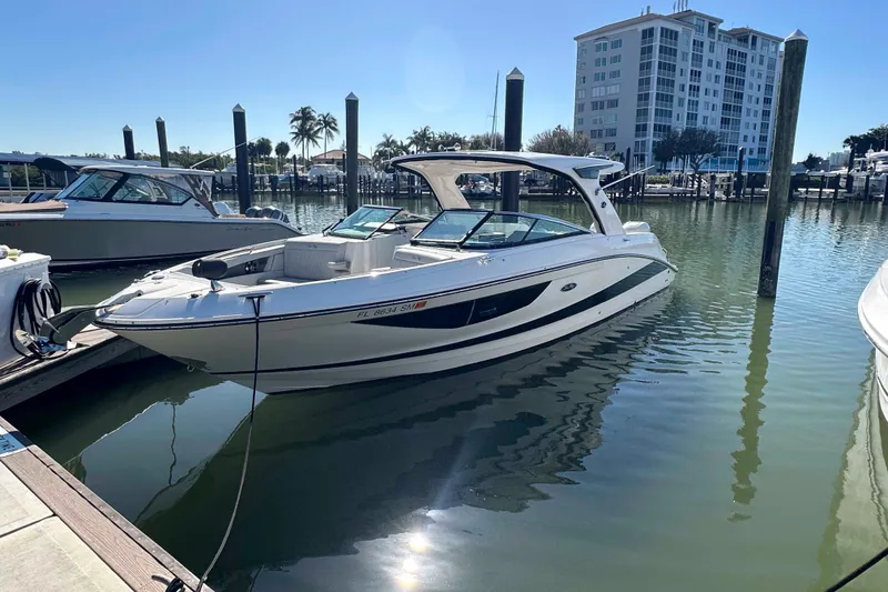 Slide: The Image of 2020 Sea Ray SLX 350 Outboard docked in a marina under clear skies. - 8