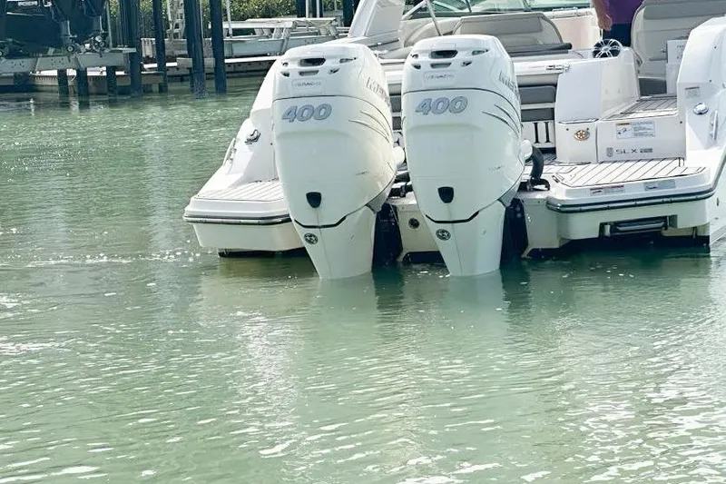 Slide: The Image of 2020 Sea Ray SLX 350 Outboard with twin 400 engines in calm water. - 9