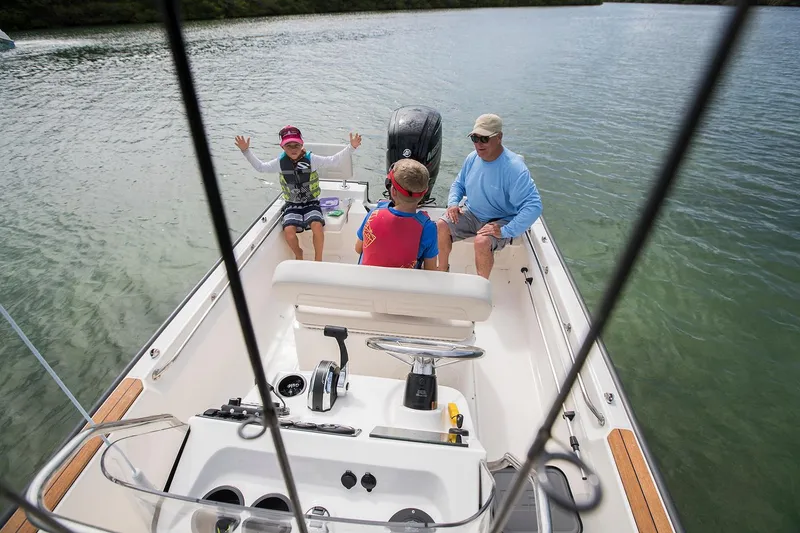 Slide: The Image of 2022 Boston Whaler 170 Montauk boat in indoor storage, featuring a clean deck and red rope. - 7