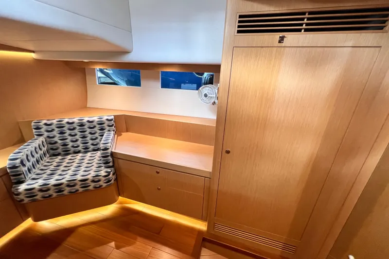 Slide: The Image of 2024 Hylas H57 yacht interior with wooden cabinetry and patterned seating. - 102