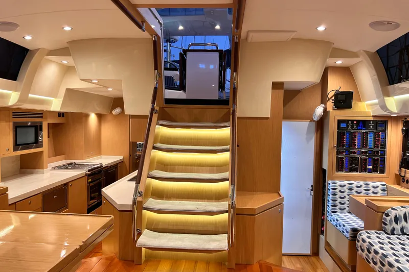 Slide: The Image of Interior of 2024 Hylas H57 yacht featuring modern kitchen and illuminated staircase. - 12