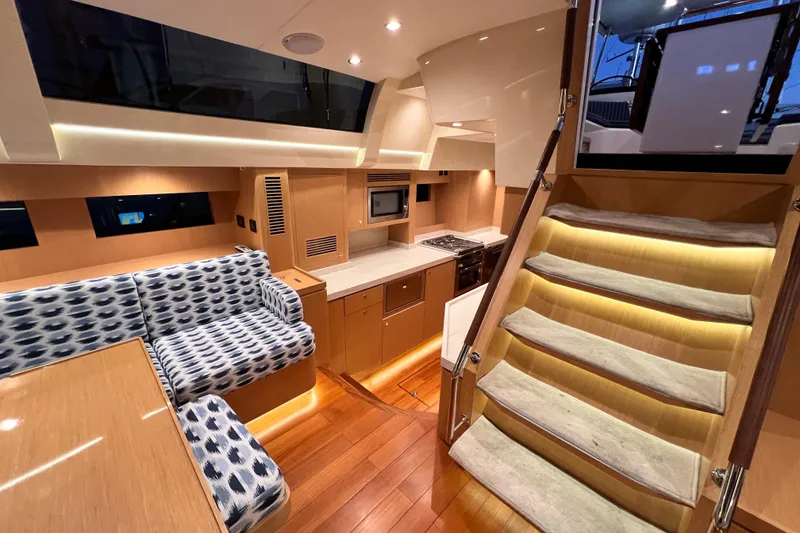Slide: The Image of Luxurious interior of 2024 Hylas H57 yacht with modern kitchen and stylish seating area. - 15