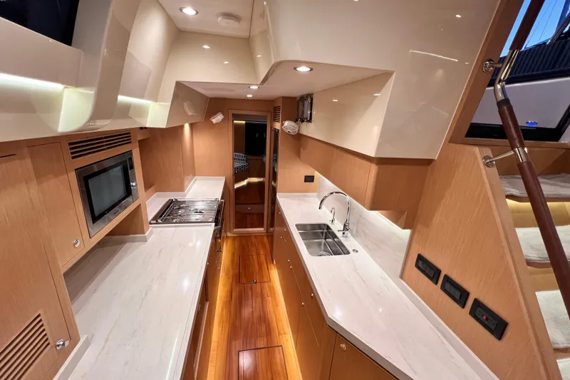 Slide: The Image of Luxurious 2024 Hylas H57 yacht interior kitchen with modern appliances and sleek design. - 17