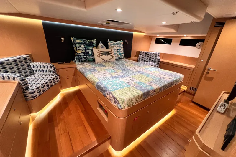 Slide: The Image of Luxurious 2024 Hylas H57 yacht cabin with elegant wood finish and cozy bedding. - 19