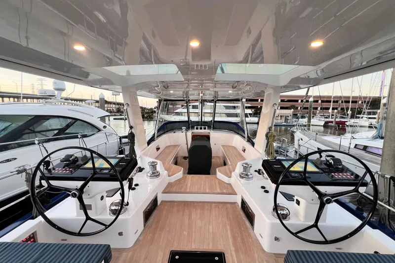 Slide: The Image of 2024 Hylas H57 yacht cockpit with dual steering wheels and modern navigation systems. - 3
