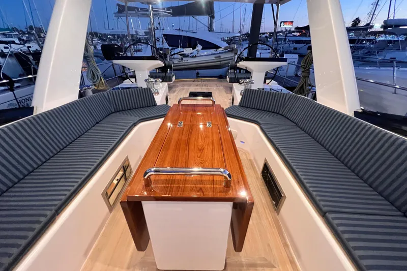 Slide: The Image of Luxurious 2024 Hylas H57 yacht cockpit with elegant seating and polished wood table. - 37