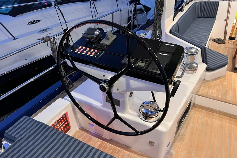 Slide: The Image of 2024 Hylas H57 yacht helm with modern navigation equipment and seating. - 40