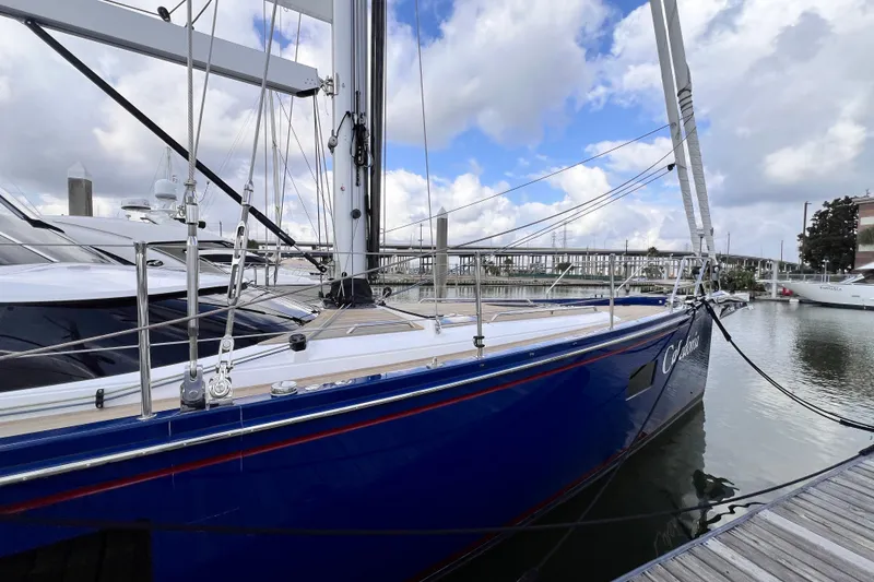 Slide: The Image of 2024 Hylas H57 yacht docked, featuring sleek blue hull and modern design. - 52