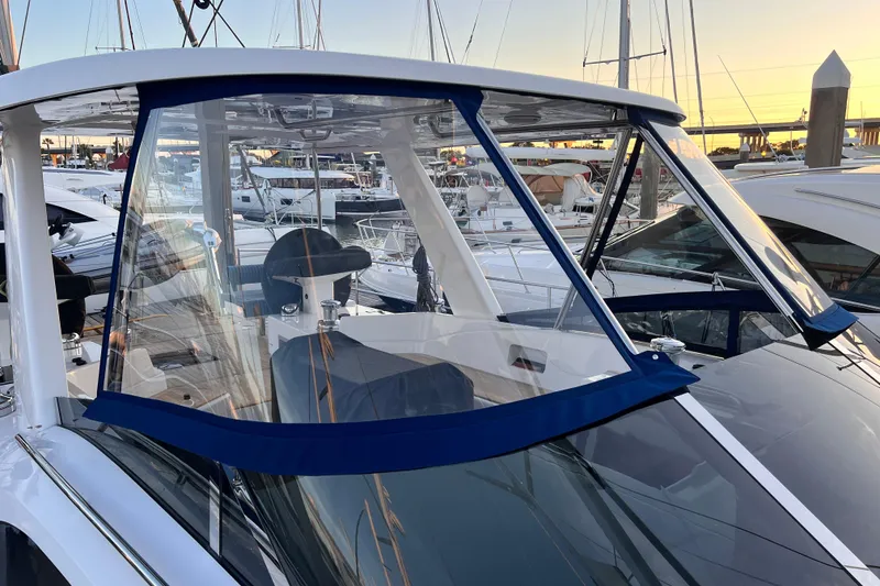 Slide: The Image of 2024 Hylas H57 yacht cockpit with clear enclosure at marina during sunset. - 54