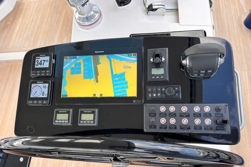 Slide: The Image of 2024 Hylas H57 yacht navigation console with digital displays and controls. - 56
