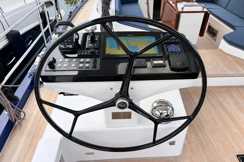 Slide: The Image of Steering wheel and navigation controls on 2024 Hylas H57 yacht deck. - 57