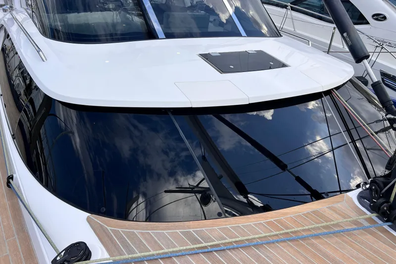 Slide: The Image of 2024 Hylas H57 yacht with sleek design and reflective windows. - 69