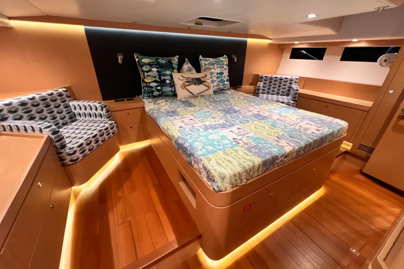Slide: The Image of Luxurious 2024 Hylas H57 yacht cabin with elegant bedding and ambient lighting. - 7