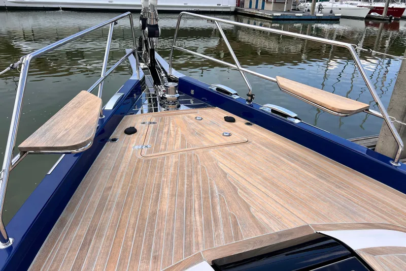 Slide: The Image of 2024 Hylas H57 yacht deck with sleek wood finish and stainless steel railings. - 77