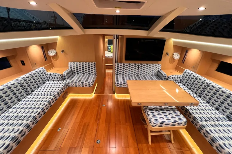 Slide: The Image of Luxurious interior of 2024 Hylas H57 yacht with patterned seating and wooden flooring. - 8