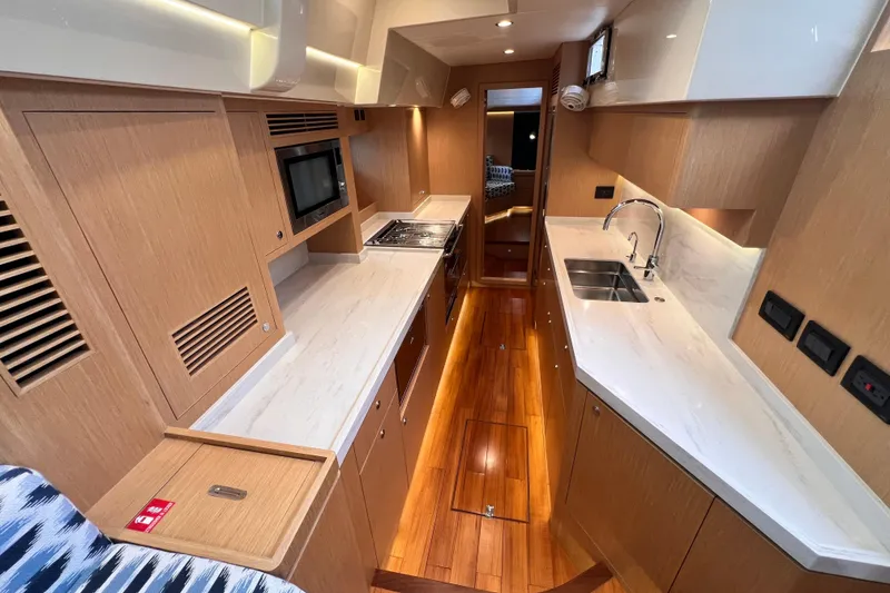 Slide: The Image of Luxurious interior of 2024 Hylas H57 yacht featuring modern kitchen design and wooden flooring. - 92