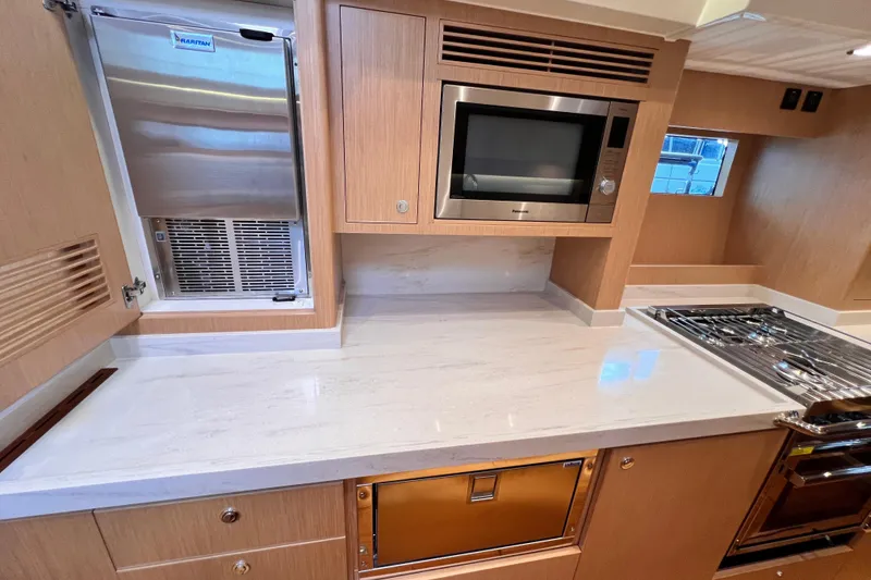 Slide: The Image of Modern kitchen in 2024 Hylas H57 yacht with sleek appliances and wood cabinetry. - 95