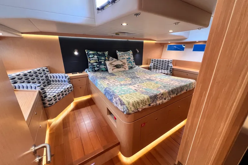 Slide: The Image of Luxurious 2024 Hylas H57 yacht cabin with elegant wood finish and cozy bedding. - 98