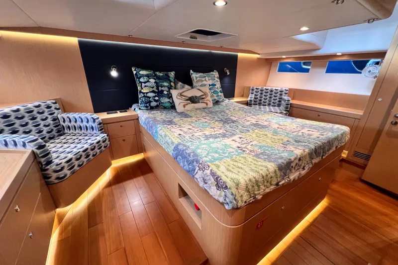 Slide: The Image of Luxurious 2024 Hylas H57 yacht cabin with elegant bedding and ambient lighting. - 99