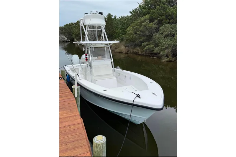 The Image of 2021 Ocean Master 27 boat docked in a serene, wooded waterway. - 1