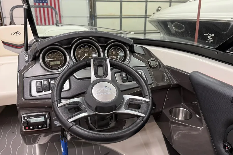 Slide: The Image of 2014 Monterey 214SS Super Sport boat dashboard with steering wheel and gauges. - 11