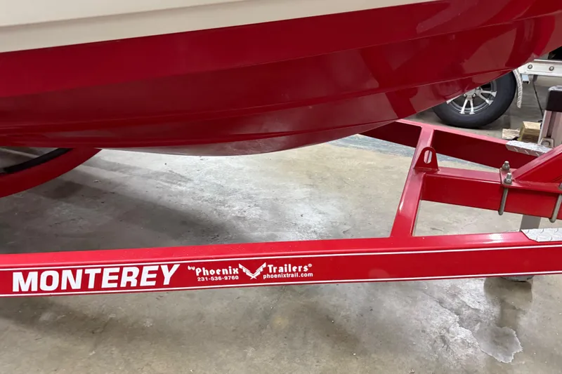 Slide: The Image of Red 2014 Monterey 214SS Super Sport boat on Phoenix trailer in garage. - 18