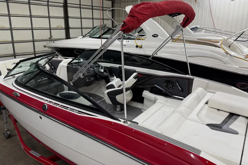 Slide: The Image of 2014 Monterey 214SS Super Sport boat with red and white interior in showroom. - 5