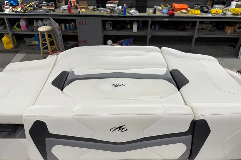 Slide: The Image of 2014 Monterey 214SS Super Sport boat interior with white and gray seating in a workshop. - 9