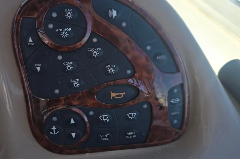 Slide: The Image of Control panel of a 2005 Sea Ray 340 Sundancer boat with various function buttons. - 16