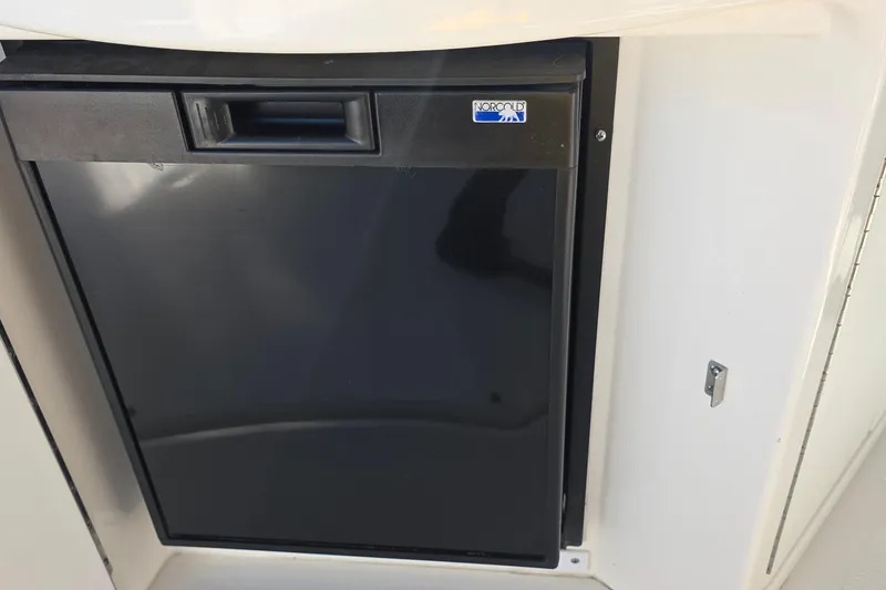 Slide: The Image of Norcold refrigerator on 2005 Sea Ray 340 Sundancer boat, black door, compact design. - 19