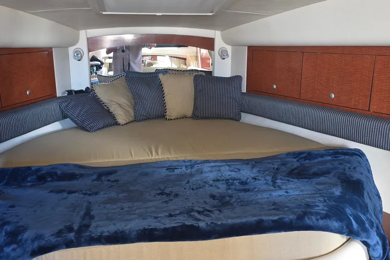Slide: The Image of Interior cabin of 2005 Sea Ray 340 Sundancer with cozy bedding and cushions. - 25
